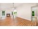 Bright living room with laminate flooring, a fireplace, and large windows offering ample natural light and a cozy atmosphere at 7106 Kinsmore Ln, Charlotte, NC 28269