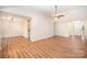 Open concept living room with laminate flooring, offering versatile space for dining and relaxation, adjacent to a welcoming entryway at 7106 Kinsmore Ln, Charlotte, NC 28269