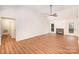 Spacious living area featuring laminate floors, a traditional fireplace, and a patio door, enhancing natural light and indoor-outdoor flow at 7106 Kinsmore Ln, Charlotte, NC 28269