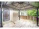 Cozy covered patio with wood flooring, offering a relaxing outdoor space at 7106 Kinsmore Ln, Charlotte, NC 28269