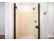 Bathroom with a walk-in shower and modern fixtures at 7106 Kinsmore Ln, Charlotte, NC 28269