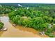 Aerial view of a wooded property featuring a lake and multiple boat docks at 8136 Energy Ln, Catawba, NC 28609