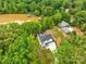 An aerial perspective of an elegant home close to the lake, embraced by verdant trees and landscape at 8136 Energy Ln, Catawba, NC 28609