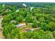 Picturesque aerial view of a property nestled among lush greenery near a serene lake, showcasing its peaceful setting at 8136 Energy Ln, Catawba, NC 28609