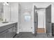 Bright bathroom with a glass enclosed shower, double vanity, and gray shaker cabinets at 8136 Energy Ln, Catawba, NC 28609
