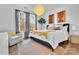 Bright bedroom showcasing hardwood floors, stylish decor, a cozy armchair, and abundant natural light at 8136 Energy Ln, Catawba, NC 28609