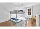 Bright bedroom features a bunk bed and a large window that provides natural light, complemented by stylish decor and hardwood floor at 8136 Energy Ln, Catawba, NC 28609