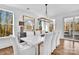 Bright dining room with hardwood floors, large windows, and a long marble table with seating at 8136 Energy Ln, Catawba, NC 28609