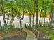 Scenic view of the dock and waterfront with lush greenery surrounding the area, creating a tranquil environment at 8136 Energy Ln, Catawba, NC 28609