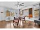 Bright game room with hardwood floors, foosball table, a large scrabble board and plenty of natural light from two large windows at 8136 Energy Ln, Catawba, NC 28609