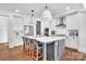 Bright kitchen featuring hardwood floors, a large island with seating, and modern appliances at 8136 Energy Ln, Catawba, NC 28609