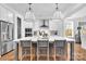 Bright kitchen featuring hardwood floors, a large island with seating, and modern appliances at 8136 Energy Ln, Catawba, NC 28609