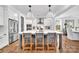 Bright kitchen featuring hardwood floors, a large island with seating, and modern appliances at 8136 Energy Ln, Catawba, NC 28609