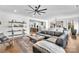 Open-concept living room with hardwood floors, stylish decor, and seamless flow to kitchen and dining area at 8136 Energy Ln, Catawba, NC 28609
