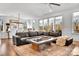 Spacious living room featuring a large sectional sofa, contemporary decor, and abundant natural light through large windows at 8136 Energy Ln, Catawba, NC 28609