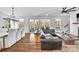 Open concept living and dining rooms with hardwood floors, a large sectional sofa, and a dining table at 8136 Energy Ln, Catawba, NC 28609