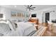 Comfortable main bedroom featuring a ceiling fan, hardwood floors, area rug, and a wall-mounted television at 8136 Energy Ln, Catawba, NC 28609