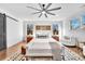 Bright and open main bedroom featuring a king-size bed, hardwood floors, and a cozy seating area, perfect for relaxation at 8136 Energy Ln, Catawba, NC 28609