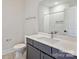 Bathroom with white tiling and gray vanity at 834 Van Every St, Charlotte, NC 28205