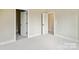 A bedroom featuring neutral walls and carpeting, with doorways leading to other rooms of the house at 834 Van Every St, Charlotte, NC 28205