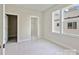 Carpeted bedroom offering multiple access points and neighborhood view at 834 Van Every St, Charlotte, NC 28205