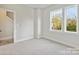A bright bedroom with natural light, featuring a doorway, double hung windows, and neutral carpeting at 834 Van Every St, Charlotte, NC 28205