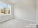 A spacious bedroom featuring plush carpeting and double hung windows that offer natural light and outdoor views at 834 Van Every St, Charlotte, NC 28205