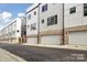 New townhomes with brick trim, modern design, and attached garages on paved street at 834 Van Every St, Charlotte, NC 28205