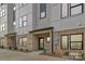 Modern townhome featuring a stylish brick facade with a gray and white color scheme at 834 Van Every St, Charlotte, NC 28205