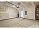 Spacious unfinished garage with visible pipes and door for storage at 834 Van Every St, Charlotte, NC 28205