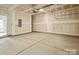 Unfinished garage with door, concrete floor, and room for storage at 834 Van Every St, Charlotte, NC 28205