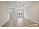 Bright, open-concept living room with hardwood floors, modern lighting, and ample space at 834 Van Every St, Charlotte, NC 28205