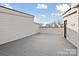 Rooftop deck with wood-look flooring, encased in white walls and offering expansive outdoor living at 834 Van Every St, Charlotte, NC 28205