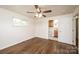 Bright bedroom features hardwood floors, ceiling fan, window and adjoins bathroom at 975 22Nd Street Ne Pl, Hickory, NC 28601