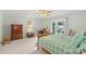 Bedroom with light green walls, ceiling fan, bed, wooden furniture, and large window at 119 Mary Louise Ct, Fort Mill, SC 29715
