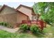 Beautiful home featuring a wooden deck, brick accents, and lush landscaping at 119 Mary Louise Ct, Fort Mill, SC 29715