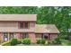 Townhome featuring brick and siding with manicured landscaping, vibrant greenery, and symmetrical design at 119 Mary Louise Ct, Fort Mill, SC 29715