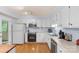 Well-lit kitchen with white cabinets, modern appliances, and ample counter space for cooking at 119 Mary Louise Ct, Fort Mill, SC 29715