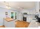 Charming kitchen with white cabinets, island with wood countertop, and door to the outside at 119 Mary Louise Ct, Fort Mill, SC 29715