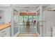 View from kitchen into sunroom with a ceiling fan and multiple windows to the backyard at 119 Mary Louise Ct, Fort Mill, SC 29715