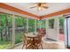 Bright sunroom with a wooden table and chairs set, windows facing the backyard, and wood ceiling fan at 119 Mary Louise Ct, Fort Mill, SC 29715