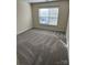 Comfortable bedroom with a large window providing plenty of natural light and soft carpet at 12120 Stratfield Place Cir, Pineville, NC 28134