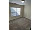 Bedroom featuring a light-filled window, neutral walls, and plush carpeting at 12120 Stratfield Place Cir, Pineville, NC 28134