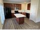 Modern kitchen featuring stainless steel appliances, a center island, and dark cabinetry with ample counter space at 12120 Stratfield Place Cir, Pineville, NC 28134