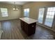 View of kitchen island with ample space and natural light from windows and patio doors at 12120 Stratfield Place Cir, Pineville, NC 28134