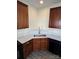 Updated kitchen displaying wood cabinetry, modern countertops, and a stainless steel sink at 12120 Stratfield Place Cir, Pineville, NC 28134