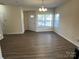 Bright and airy living room featuring new flooring, large windows, and a welcoming atmosphere at 12120 Stratfield Place Cir, Pineville, NC 28134