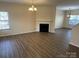 Spacious living room showcasing a cozy fireplace, new flooring, and an open layout perfect for gatherings at 12120 Stratfield Place Cir, Pineville, NC 28134