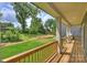 Back porch overlooking sprawling yard with beautiful trees and green grass at 205 Coxe Ave, Charlotte, NC 28208