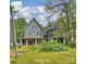 View of the spacious backyard and exterior elevations of two beautiful new homes at 205 Coxe Ave, Charlotte, NC 28208